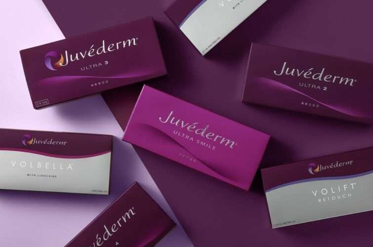 several boxes of juvederm products on a purple surface