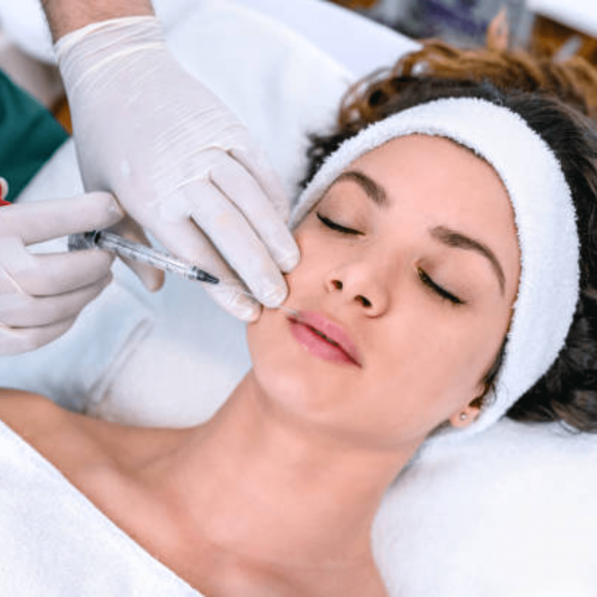 a person is getting their face done by an aesthetician