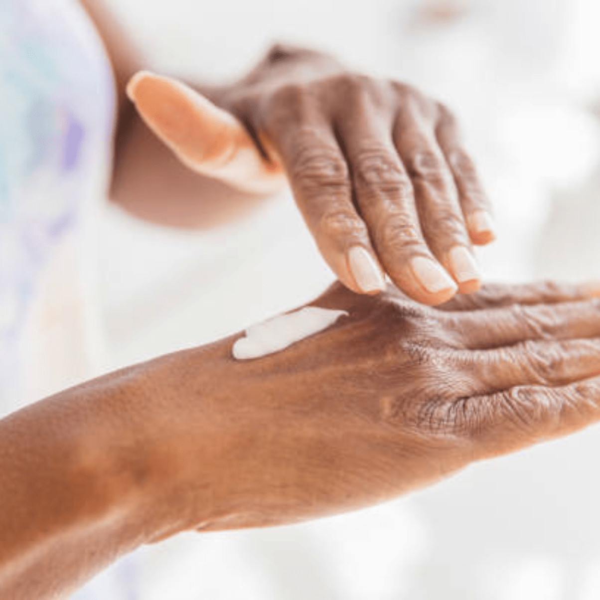 a photo of an aged hands with a topical cream for body rejuvenation