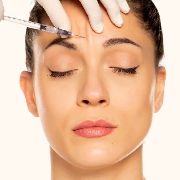 woman with her face close up, getting a Dysport injection on her forehead