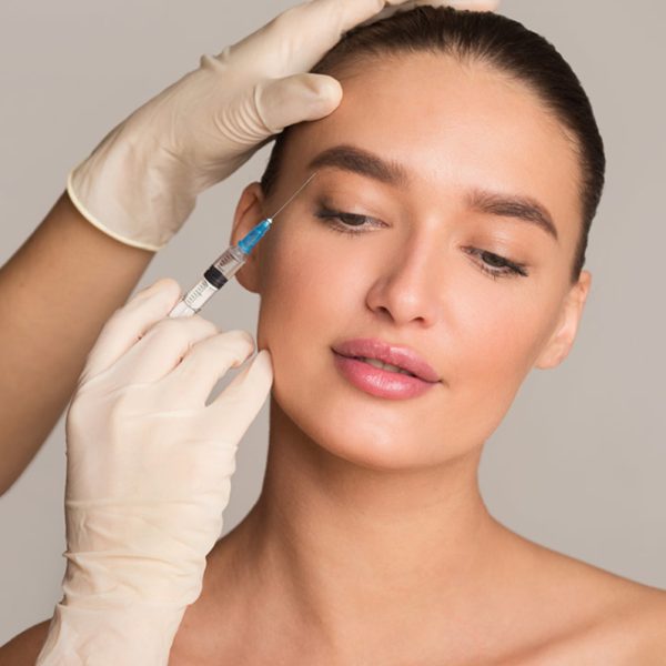 woman getting botox on her eyebrow